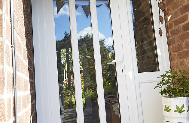 Modern front door in white UPVC with glass panels
