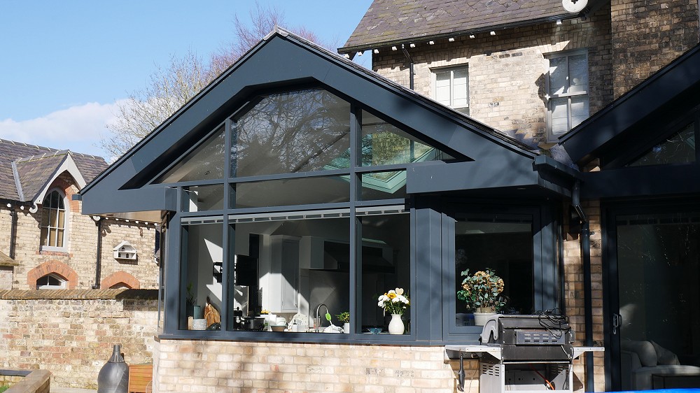 Grey aluminium curtain walling on large detached house